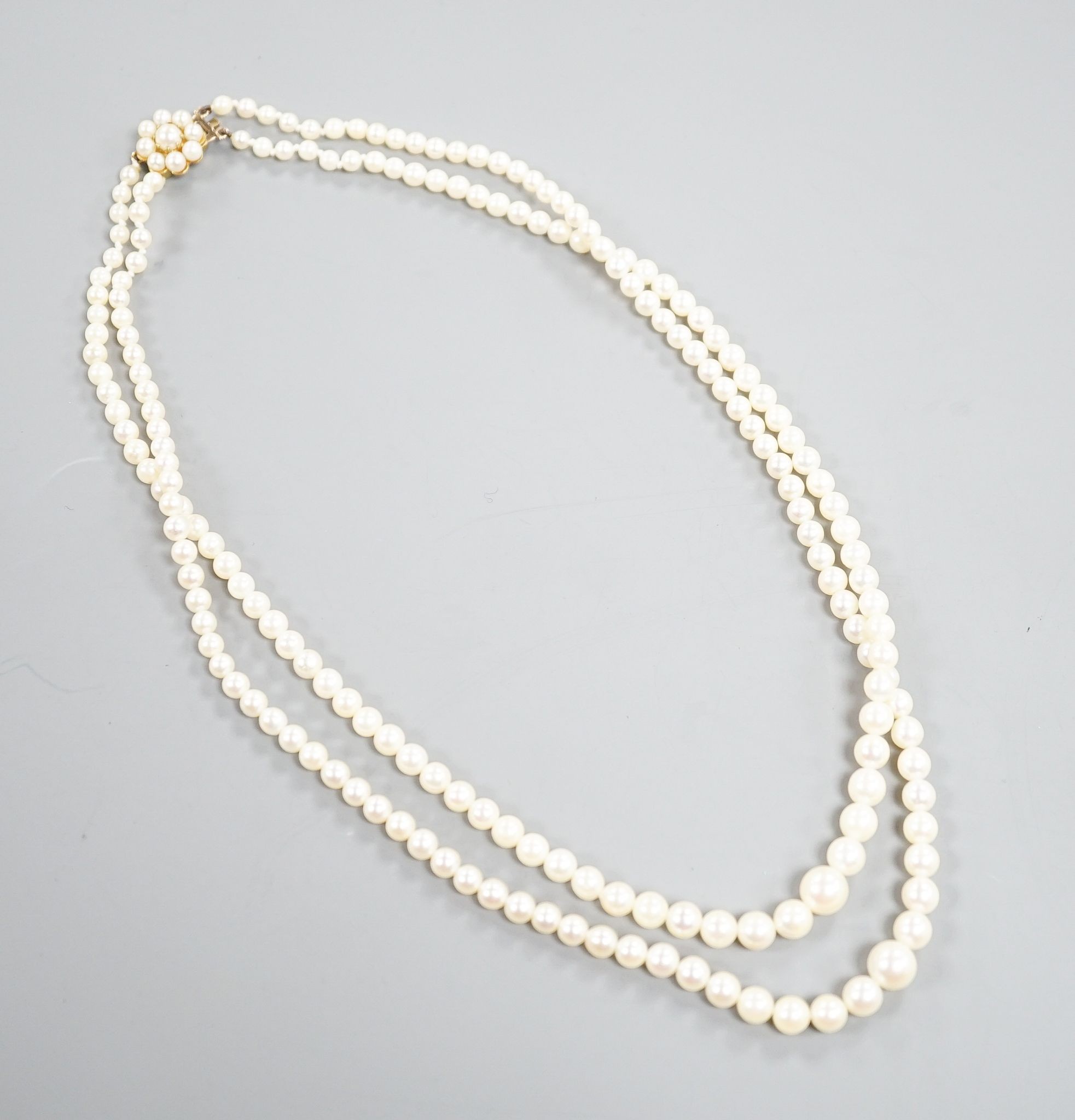 A double strand cultured pearl necklace, with 9ct and cultured pearl cluster clasp, 43cm.